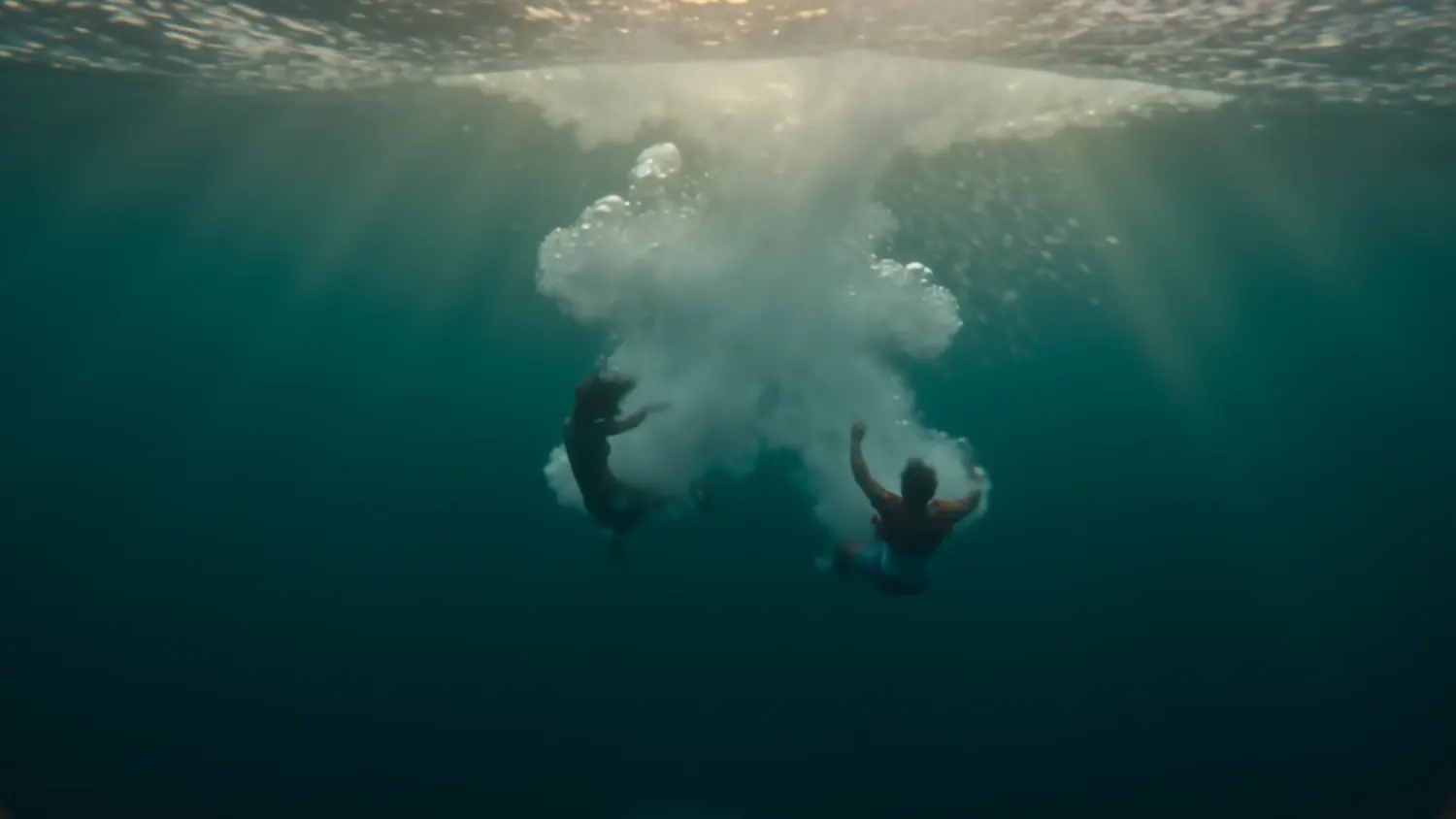 Two protagonists entering the ocean underwater